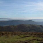 Panoramic landscape of rolling hills and blue sky near Dick Turpin Cottage.