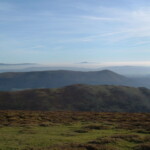 Panoramic landscape of rolling hills and blue sky near Dick Turpin Cottage.