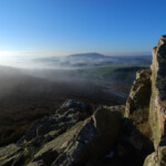 Scenic view of Shropshire landscape with rocks and mist at sunrise.