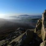 Scenic view of Shropshire landscape with rocks and mist at sunrise.