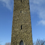 Ancient stone watchtower in Shropshire under blue sky.