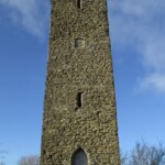 Ancient stone watchtower in Shropshire under blue sky.